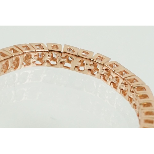 344 - Silver rose gold pated and cubic zirconia line bracelet being set throughout with square cut CS's. C... 