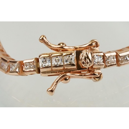 344 - Silver rose gold pated and cubic zirconia line bracelet being set throughout with square cut CS's. C... 