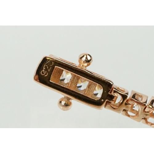 344 - Silver rose gold pated and cubic zirconia line bracelet being set throughout with square cut CS's. C... 