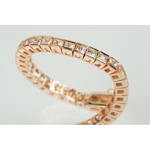 344 - Silver rose gold pated and cubic zirconia line bracelet being set throughout with square cut CS's. C... 