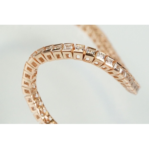 344 - Silver rose gold pated and cubic zirconia line bracelet being set throughout with square cut CS's. C... 