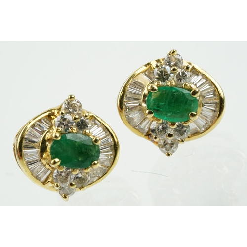 345 - Pair of 18ct gold emerald and diamond cluster earrings each being set with a central oval cut emeral... 