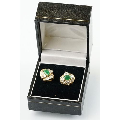 345 - Pair of 18ct gold emerald and diamond cluster earrings each being set with a central oval cut emeral... 