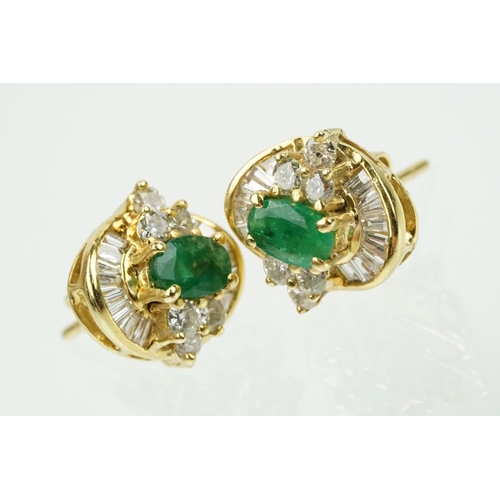 345 - Pair of 18ct gold emerald and diamond cluster earrings each being set with a central oval cut emeral... 