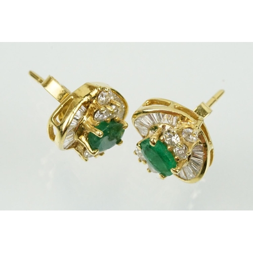 345 - Pair of 18ct gold emerald and diamond cluster earrings each being set with a central oval cut emeral... 