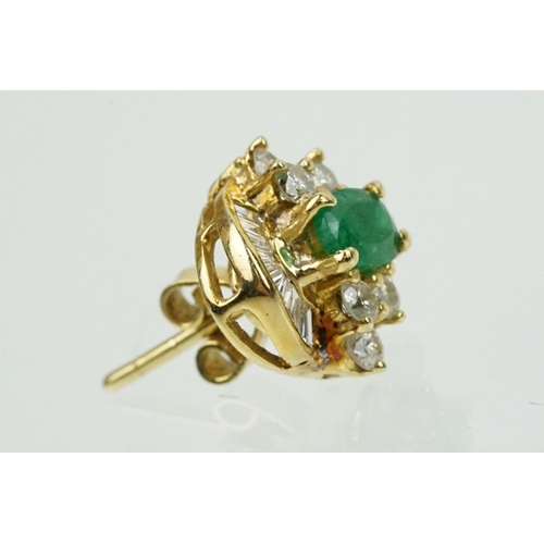 345 - Pair of 18ct gold emerald and diamond cluster earrings each being set with a central oval cut emeral... 