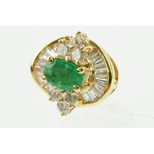 345 - Pair of 18ct gold emerald and diamond cluster earrings each being set with a central oval cut emeral... 