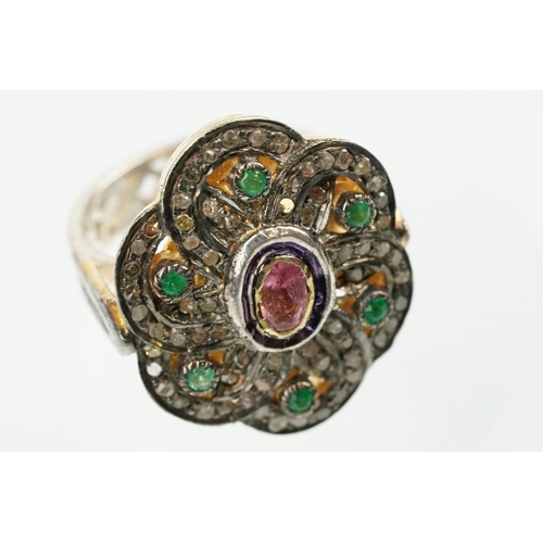 346 - Silver gilt dress ring having a flower shaped panel set with a pink tourmaline to centre, surrounded... 