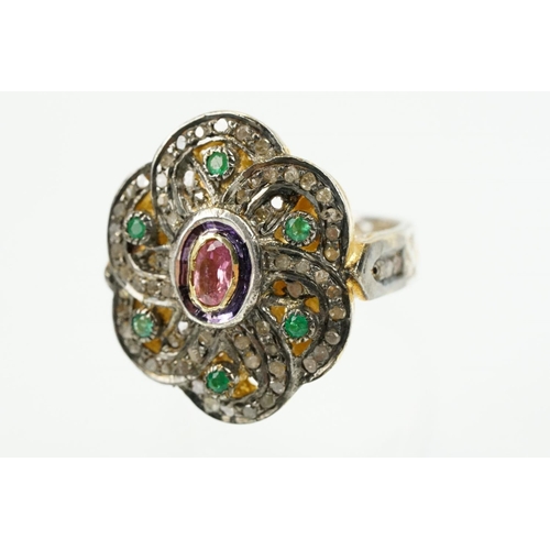 346 - Silver gilt dress ring having a flower shaped panel set with a pink tourmaline to centre, surrounded... 