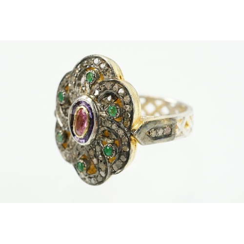 346 - Silver gilt dress ring having a flower shaped panel set with a pink tourmaline to centre, surrounded... 