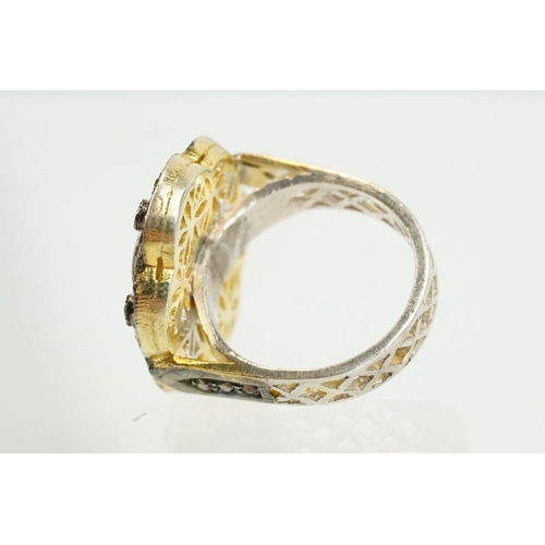 346 - Silver gilt dress ring having a flower shaped panel set with a pink tourmaline to centre, surrounded... 