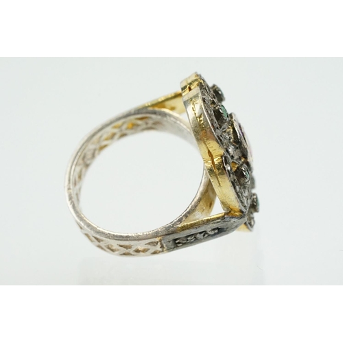 346 - Silver gilt dress ring having a flower shaped panel set with a pink tourmaline to centre, surrounded... 