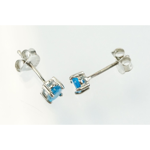 352 - Pair of silver and blue apatite gemstone stud earrings being set with a single oval cut stone to eac... 