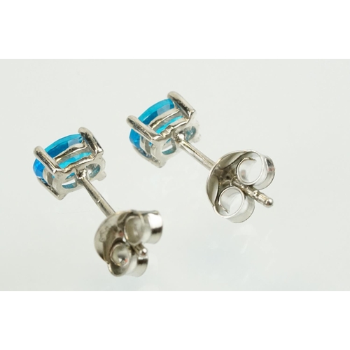 352 - Pair of silver and blue apatite gemstone stud earrings being set with a single oval cut stone to eac... 