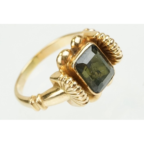 355 - Green tourmaline 18ct yellow gold ring, the rectangular mixed cut tourmaline measuring approx 8 x 6.... 