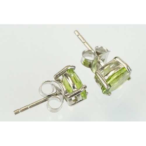 360 - Pair of silver and peridot stud earrings being set with oval cut peridots. Marked 925. Measures 7mm.