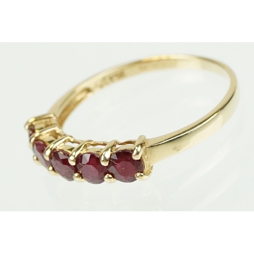 364 - Ruby 14ct yellow gold ring, five round mixed cut rubies, diameter approx 3.5mm, shared claw settings... 