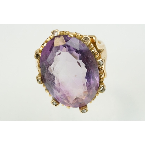 383 - Amethyst and diamond unmarked yellow gold ring, the large oval mixed cut amethyst measuring approx 2... 