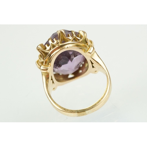 383 - Amethyst and diamond unmarked yellow gold ring, the large oval mixed cut amethyst measuring approx 2... 