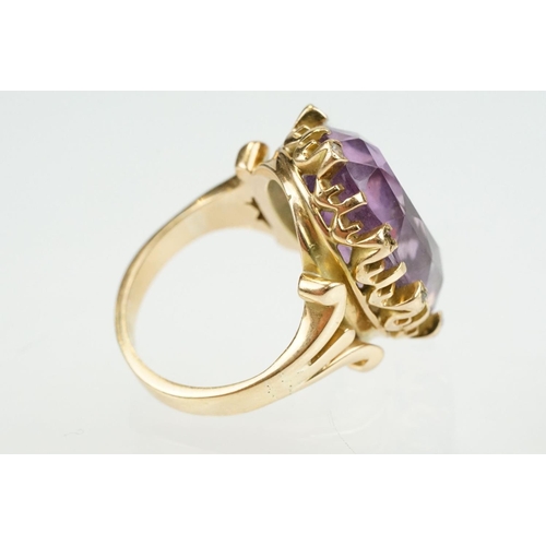 383 - Amethyst and diamond unmarked yellow gold ring, the large oval mixed cut amethyst measuring approx 2... 