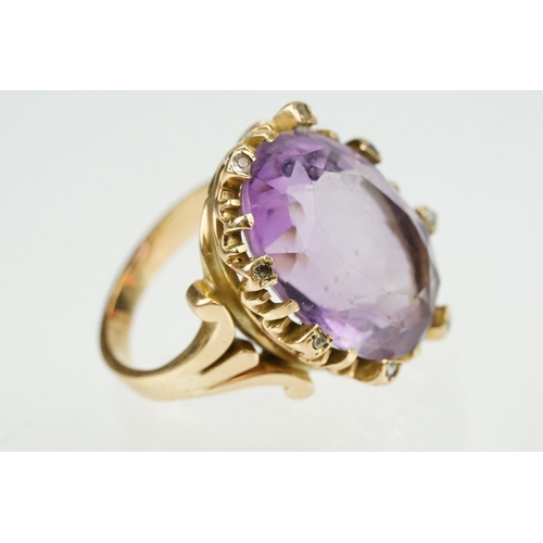 383 - Amethyst and diamond unmarked yellow gold ring, the large oval mixed cut amethyst measuring approx 2... 