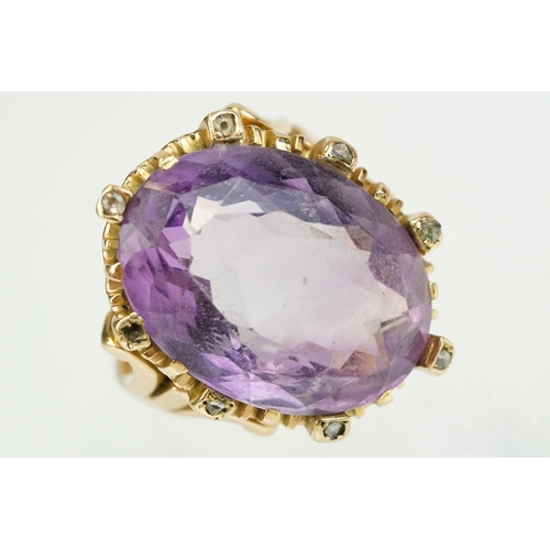 383 - Amethyst and diamond unmarked yellow gold ring, the large oval mixed cut amethyst measuring approx 2... 