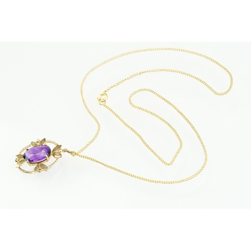 385 - 9ct gold and amethyst pendant necklace being set with an oval cut amethyst in a open work setting on... 