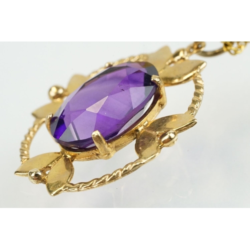 385 - 9ct gold and amethyst pendant necklace being set with an oval cut amethyst in a open work setting on... 