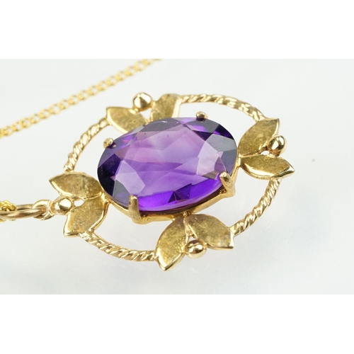 385 - 9ct gold and amethyst pendant necklace being set with an oval cut amethyst in a open work setting on... 