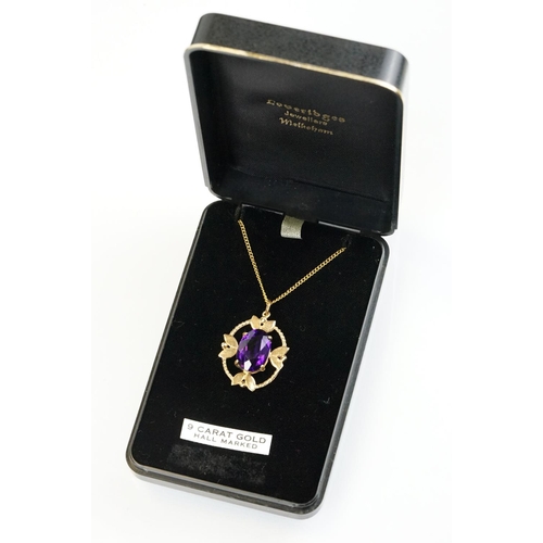 385 - 9ct gold and amethyst pendant necklace being set with an oval cut amethyst in a open work setting on... 