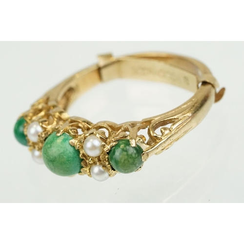 387 - 9ct gold turquoise and pearl ring being set with three green cabochons set with four pearls in betwe... 