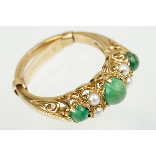 387 - 9ct gold turquoise and pearl ring being set with three green cabochons set with four pearls in betwe... 