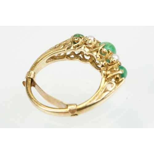 387 - 9ct gold turquoise and pearl ring being set with three green cabochons set with four pearls in betwe... 