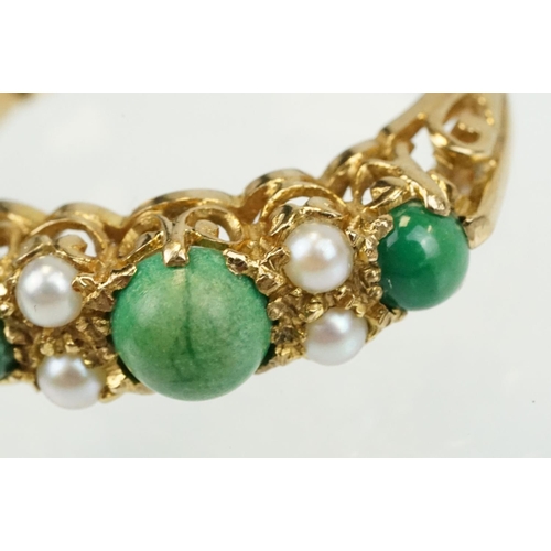 387 - 9ct gold turquoise and pearl ring being set with three green cabochons set with four pearls in betwe... 