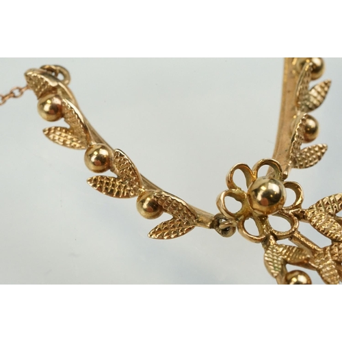 388 - 9ct gold vintage collar necklace having a foliate design centre mounted to fine chains with a spring... 