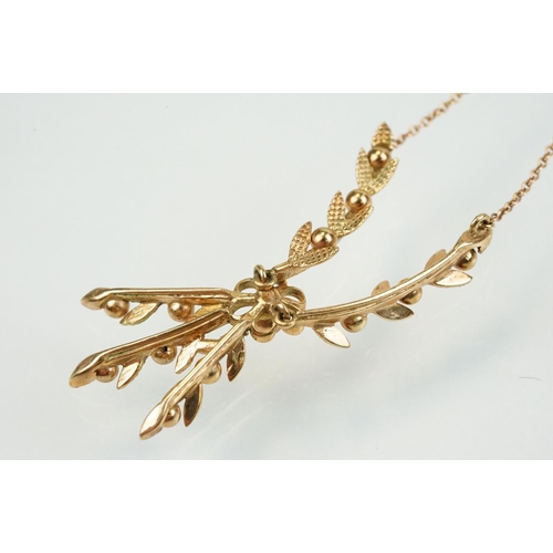 388 - 9ct gold vintage collar necklace having a foliate design centre mounted to fine chains with a spring... 