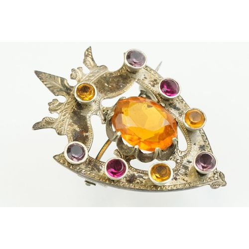 389 - 19th Century Victorian yellow metal knot brooch being bezel set with eight oval cut purple stones (u... 