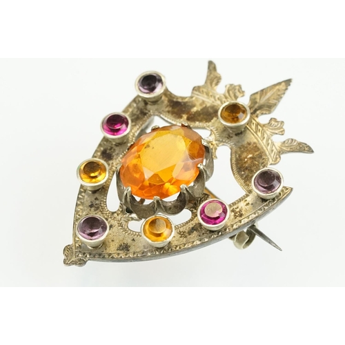 389 - 19th Century Victorian yellow metal knot brooch being bezel set with eight oval cut purple stones (u... 