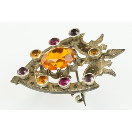 389 - 19th Century Victorian yellow metal knot brooch being bezel set with eight oval cut purple stones (u... 