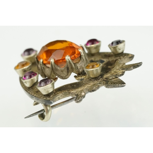 389 - 19th Century Victorian yellow metal knot brooch being bezel set with eight oval cut purple stones (u... 