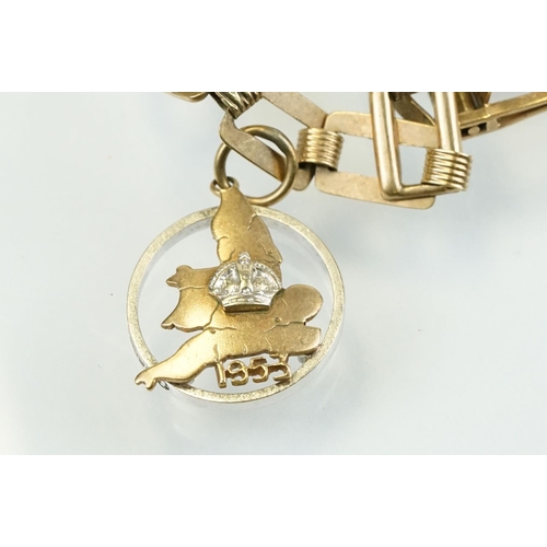 392 - 9ct gold charm bracelet having a square link bracelet chain with eight hallmarked 9ct gold charms. T... 