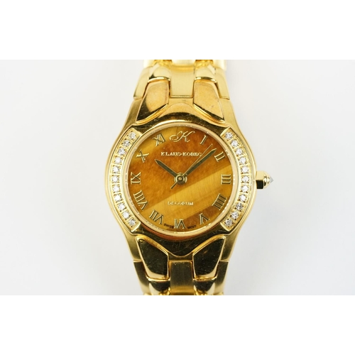 500 - Klaus-Koberc Decorum gold plated wrist watch having a tigers eye style dial, with diamonds set to th... 