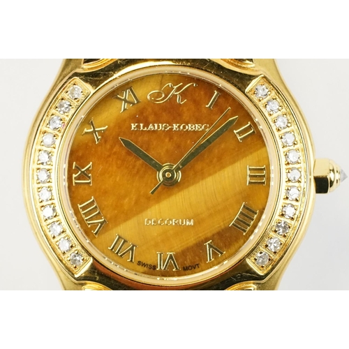 500 - Klaus-Koberc Decorum gold plated wrist watch having a tigers eye style dial, with diamonds set to th... 