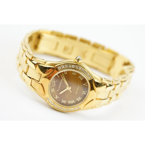 500 - Klaus-Koberc Decorum gold plated wrist watch having a tigers eye style dial, with diamonds set to th... 