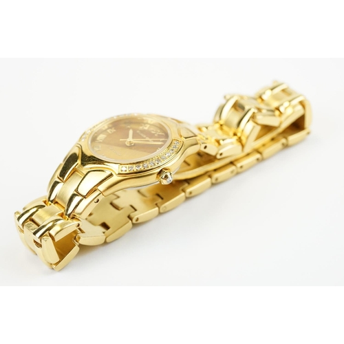 500 - Klaus-Koberc Decorum gold plated wrist watch having a tigers eye style dial, with diamonds set to th... 