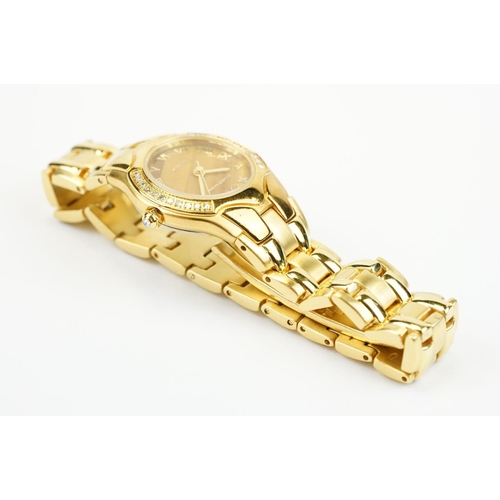 500 - Klaus-Koberc Decorum gold plated wrist watch having a tigers eye style dial, with diamonds set to th... 