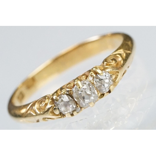 57 - Early 20th Century 18ct gold and diamond three stone ring rectangular cut diamonds set to a scrolled... 