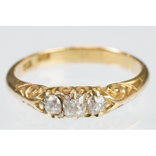 57 - Early 20th Century 18ct gold and diamond three stone ring rectangular cut diamonds set to a scrolled... 