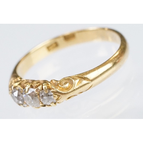 57 - Early 20th Century 18ct gold and diamond three stone ring rectangular cut diamonds set to a scrolled... 