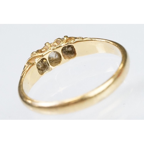 57 - Early 20th Century 18ct gold and diamond three stone ring rectangular cut diamonds set to a scrolled... 